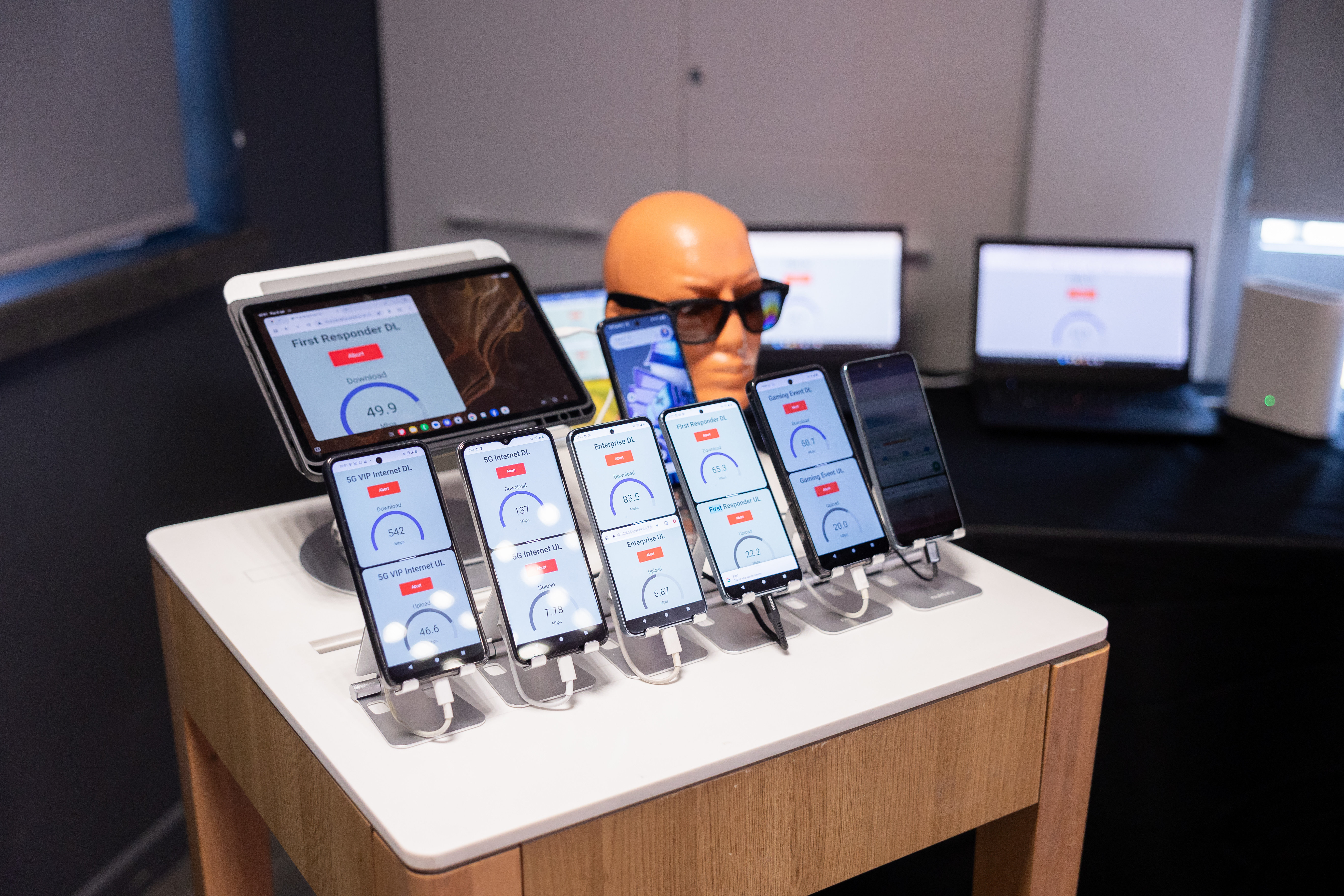 Smartphones and radio-testing equipment on an editorial desk